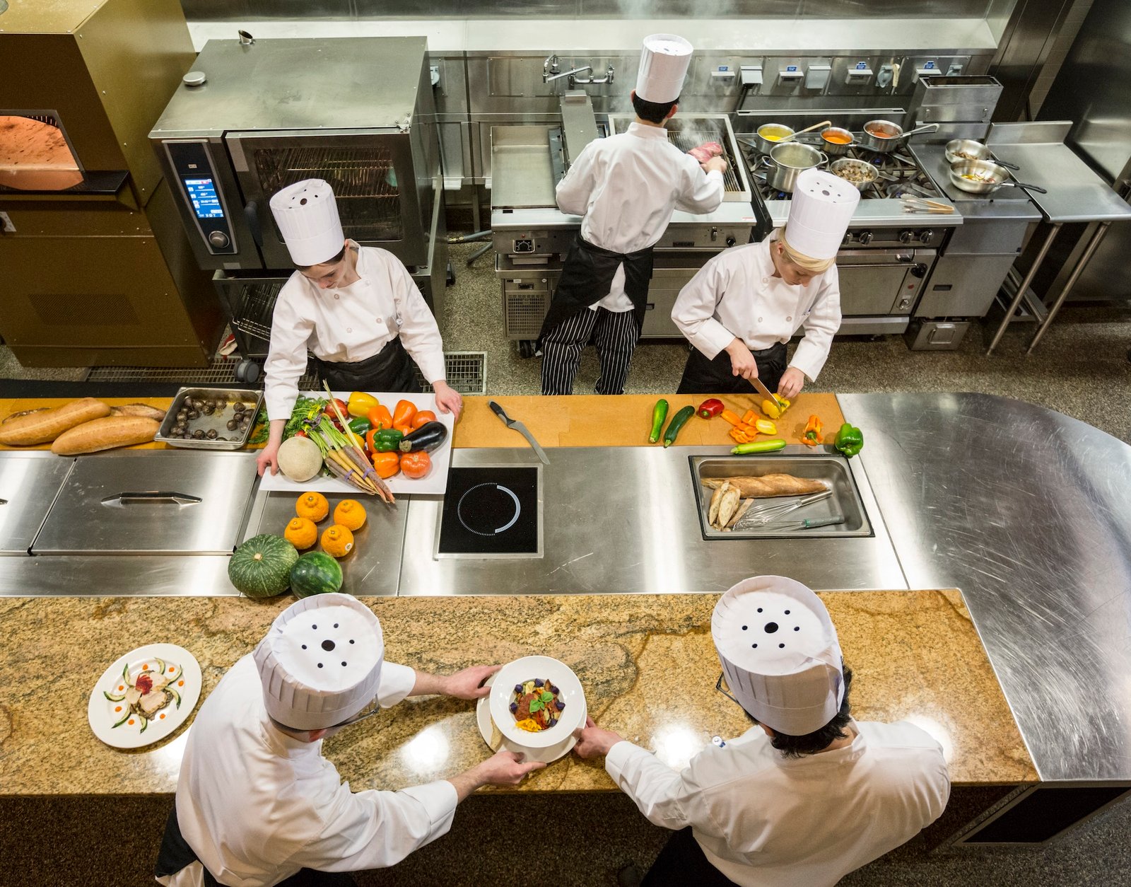 a-view-looking-down-on-a-crew-of-chefs-working-in-a-commercial-kitchen-.jpg